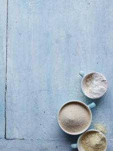 Blue background cups of sugar and flour